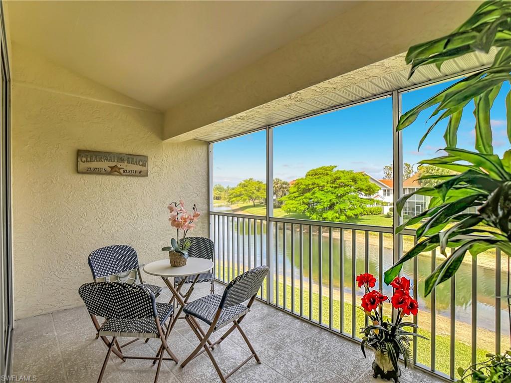 4970 Deerfield Way, Unit F203 Naples, FL 34110 - Photo 42 of 47 a view of a chairs and table in patio