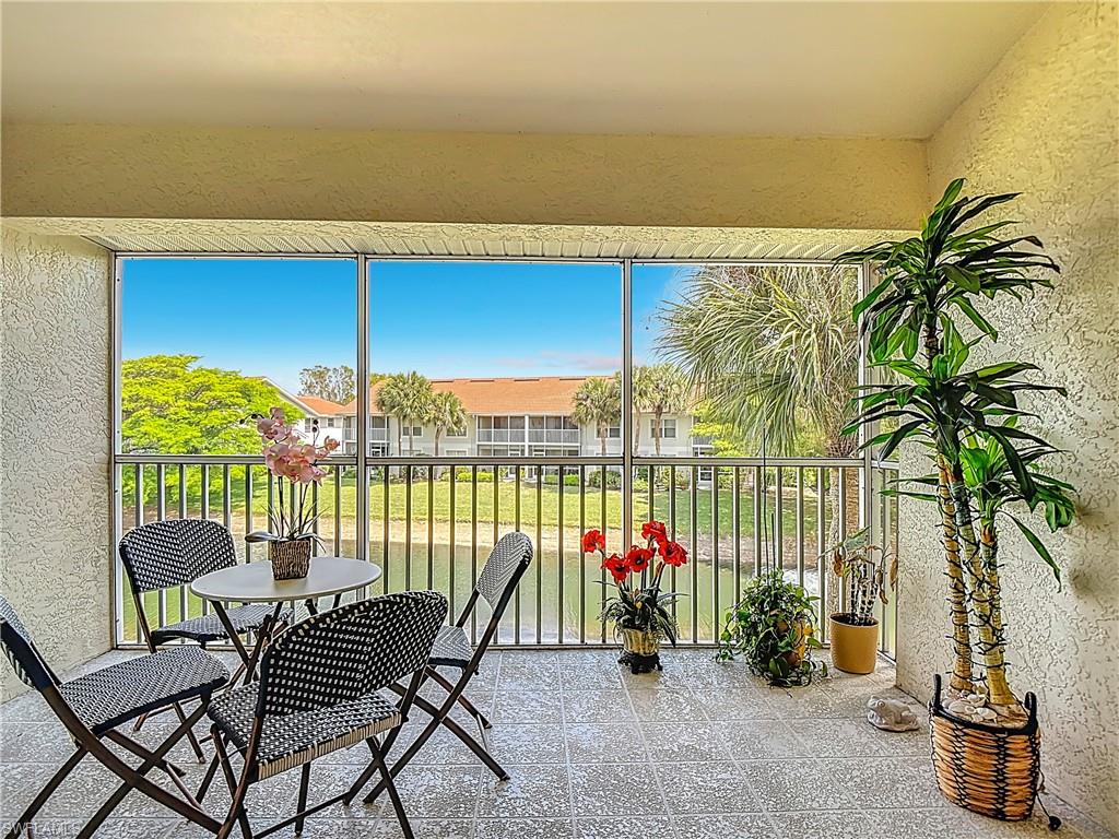 4970 Deerfield Way, Unit F203 Naples, FL 34110 - Photo 43 of 47 a group of people sitting in a balcony