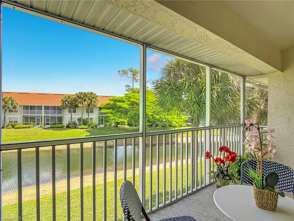 4970 Deerfield Way, Unit F203 Naples, FL 34110 - Photo 45 of 47 a view of a chairs and table in the balcony