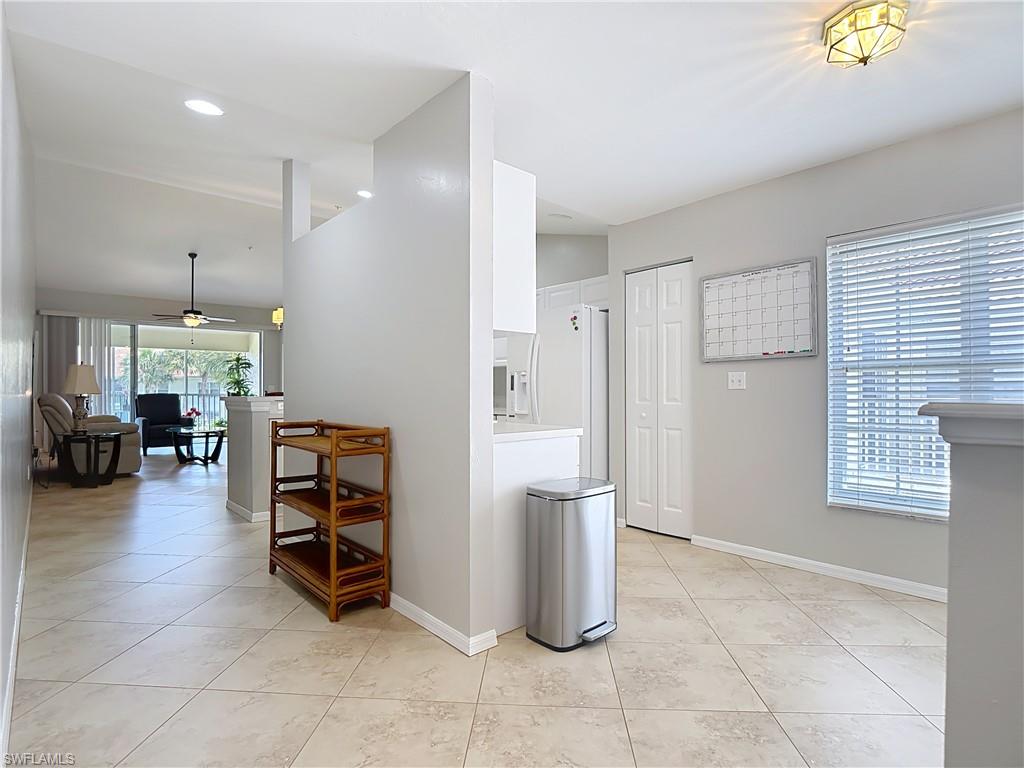 4970 Deerfield Way, Unit F203 Naples, FL 34110 - Photo 8 of 47 a view of kitchen with furniture and refrigerator