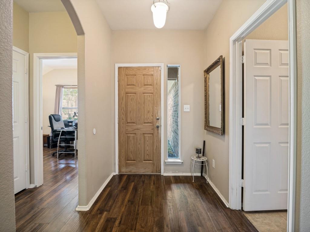 119 Robin Lane Forney, TX 75126 - Photo 4 of 27 Entryway featuring wood-finish flooring, a six-panel wood door, and an overhead flush-mount light fixture