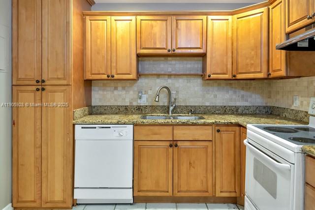 22765 Southwest 66th Avenue, Unit 205 Boca Raton, FL 33428 - Photo 15 of 24 a kitchen with stainless steel appliances granite countertop white cabinets and a sink