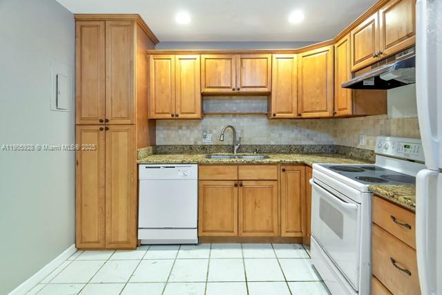 22765 Southwest 66th Avenue, Unit 205 Boca Raton, FL 33428 - Photo 16 of 24 a kitchen with stainless steel appliances granite countertop a sink stove and refrigerator