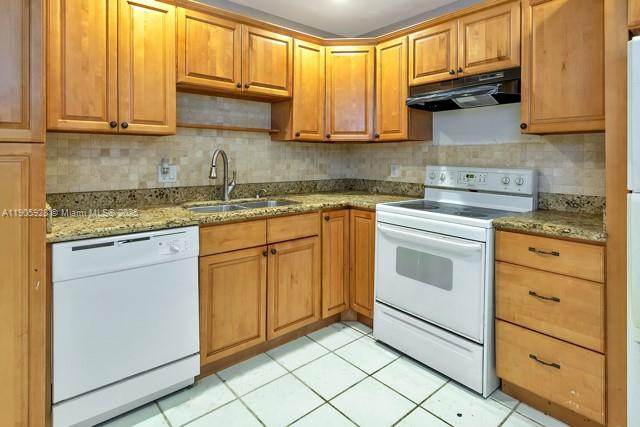 22765 Southwest 66th Avenue, Unit 205 Boca Raton, FL 33428 - Photo 17 of 24 a kitchen with granite countertop cabinets stainless steel appliances and a sink