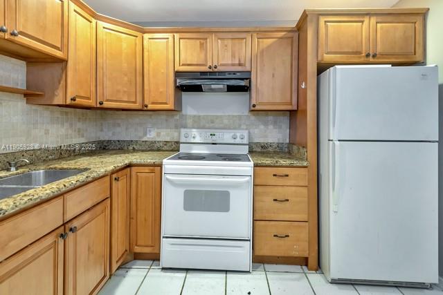 22765 Southwest 66th Avenue, Unit 205 Boca Raton, FL 33428 - Photo 18 of 24 a kitchen with appliances a sink and cabinets