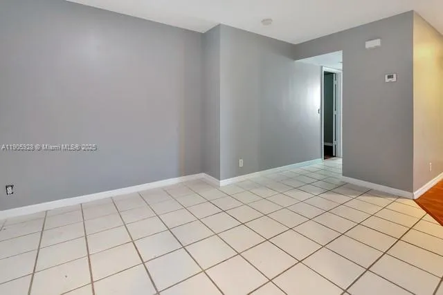 a bathroom with a granite countertop toilet sink and mirror