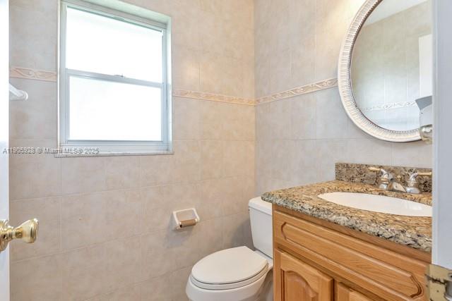 22765 Southwest 66th Avenue, Unit 205 Boca Raton, FL 33428 - Photo 20 of 24 a bathroom with a granite countertop toilet sink and mirror