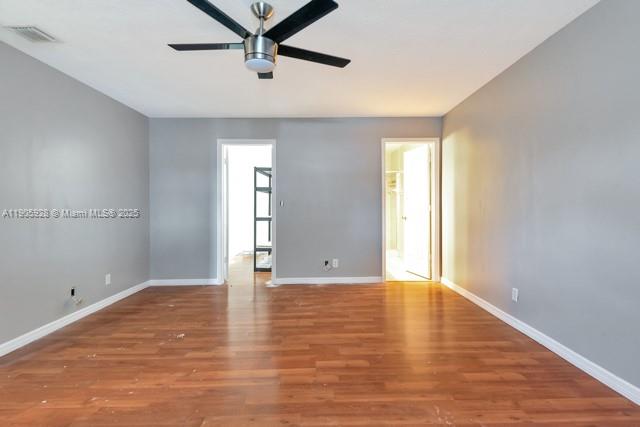 22765 Southwest 66th Avenue, Unit 205 Boca Raton, FL 33428 - Photo 21 of 24 a view of an empty room with window and wooden floor