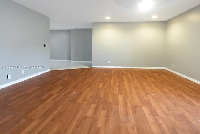 22765 Southwest 66th Avenue, Unit 205 Boca Raton, FL 33428 - Photo 5 of 24 a view of an empty room with wooden floor