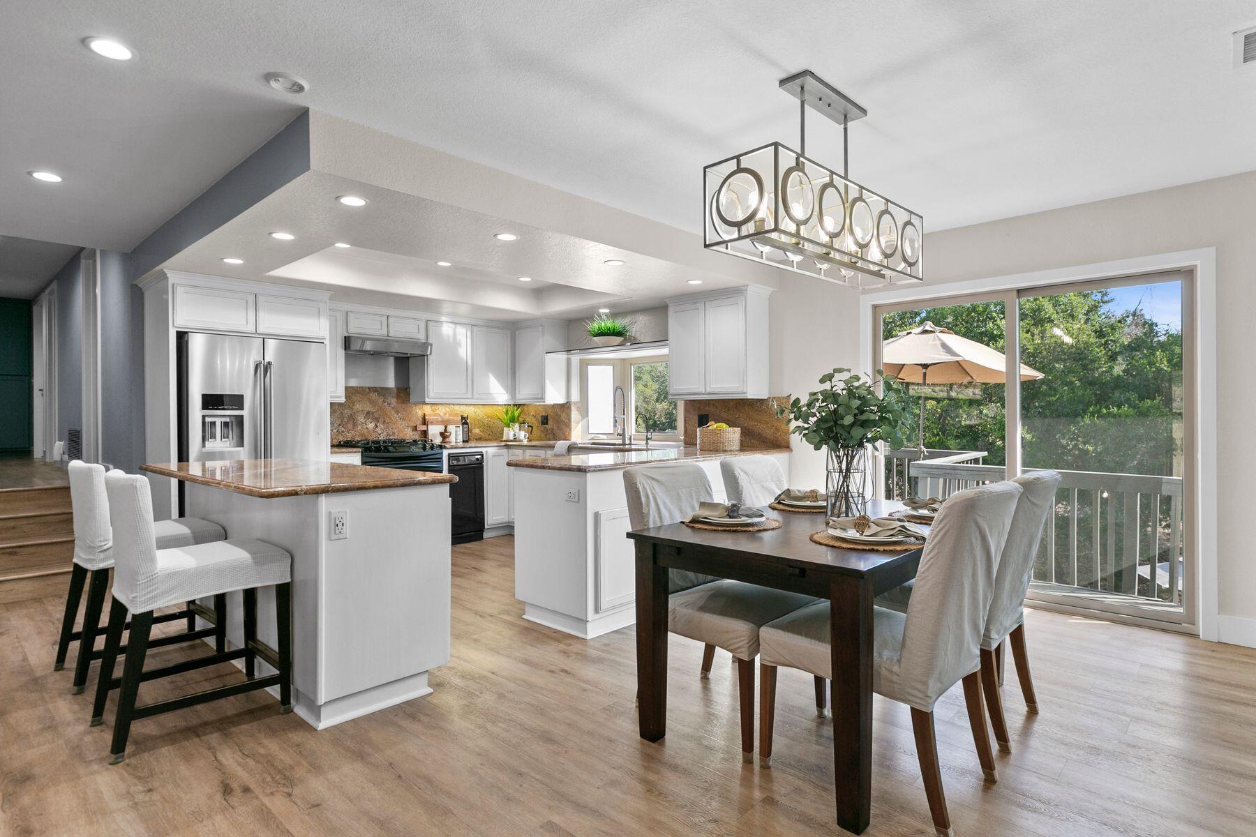 217 Sunset Street Oak View, CA 93022 - Photo 11 of 28 a view of a dining room and livingroom with furniture wooden floor a chandelier
