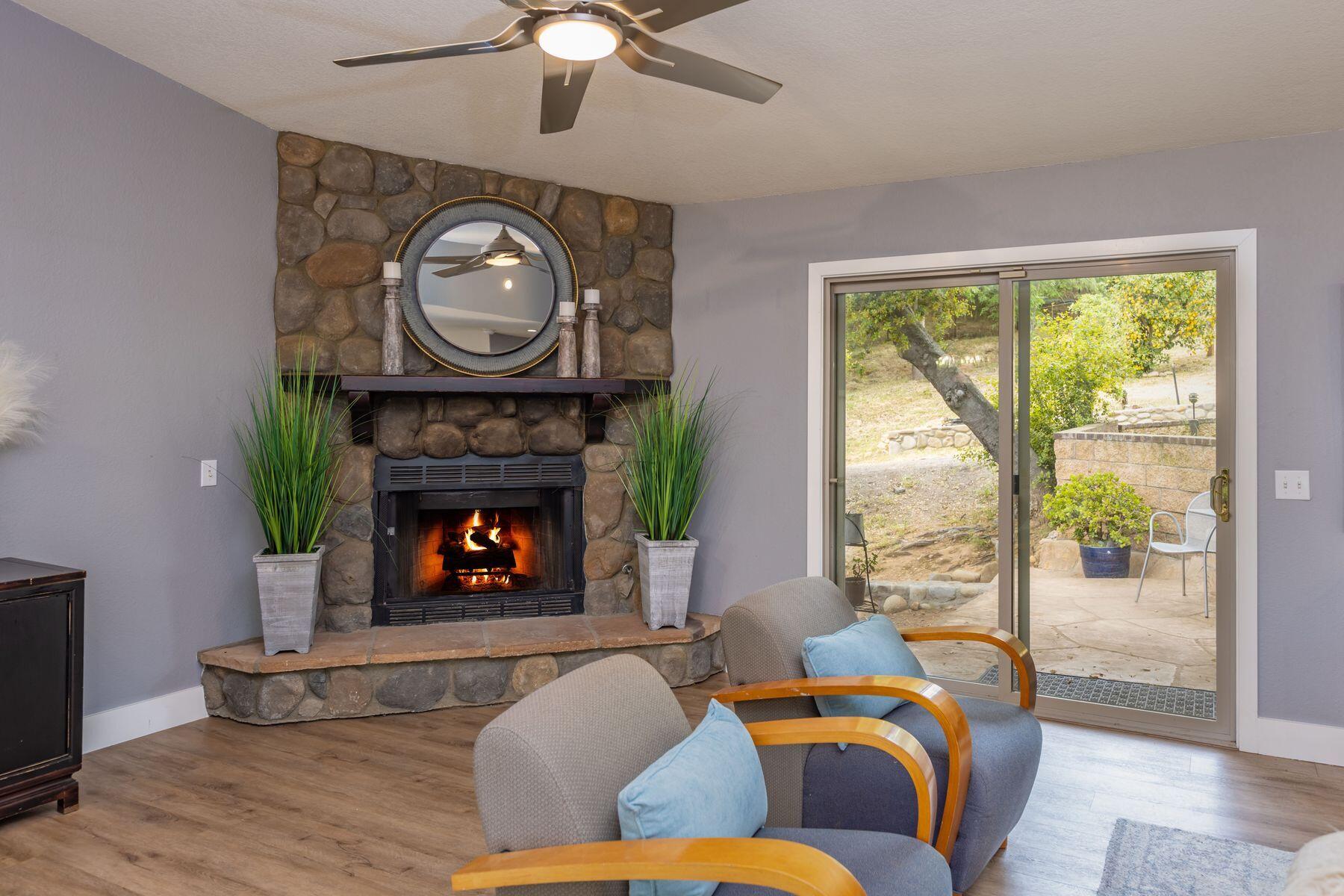 217 Sunset Street Oak View, CA 93022 - Photo 5 of 28 a living room with furniture a fireplace and a large window
