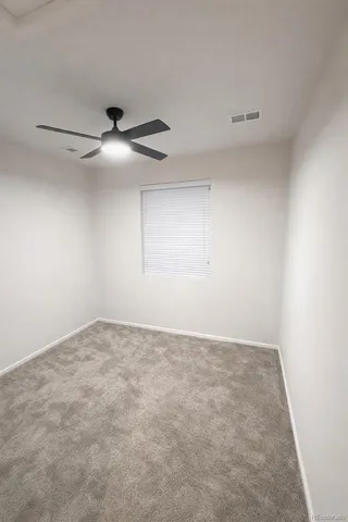 a spacious bedroom with a bed and a dresser