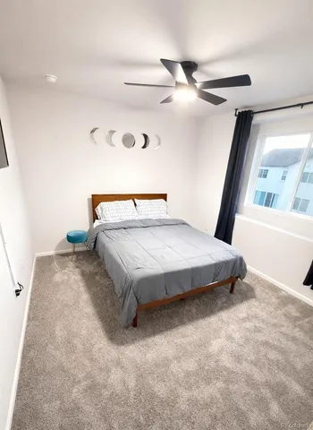 a bedroom with bed and window