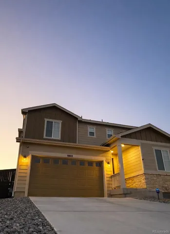 a view of a brick house with large windows