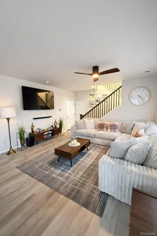 a view of a workspace with furniture and a window