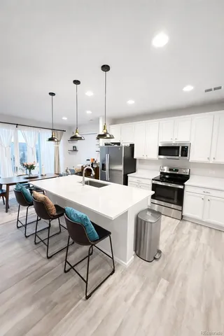 a spacious bedroom with a bed and a flat screen tv