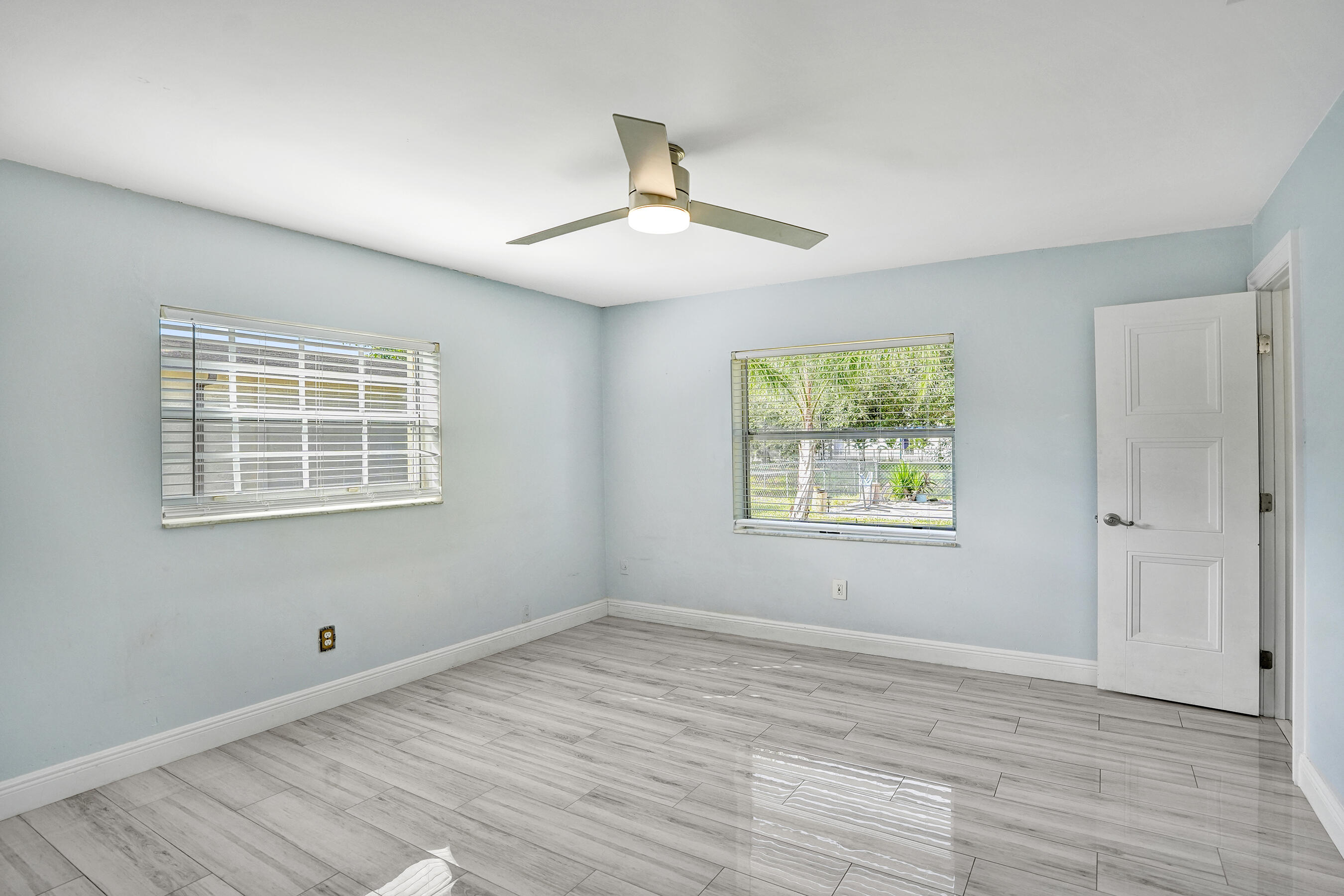 22335 Boulder Street Boca Raton, FL 33428 - Photo 16 of 36 a view of an empty room with wooden floor and a window