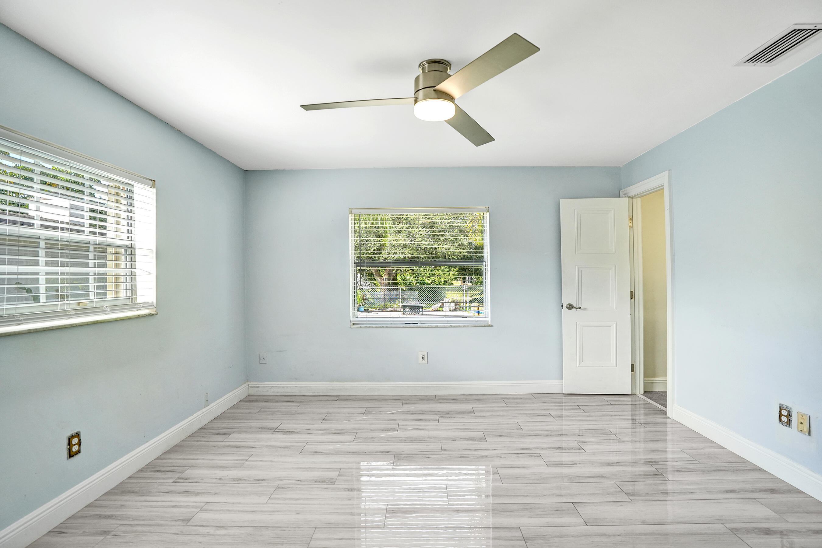 22335 Boulder Street Boca Raton, FL 33428 - Photo 19 of 36 a view of an empty room with a window and wooden floor