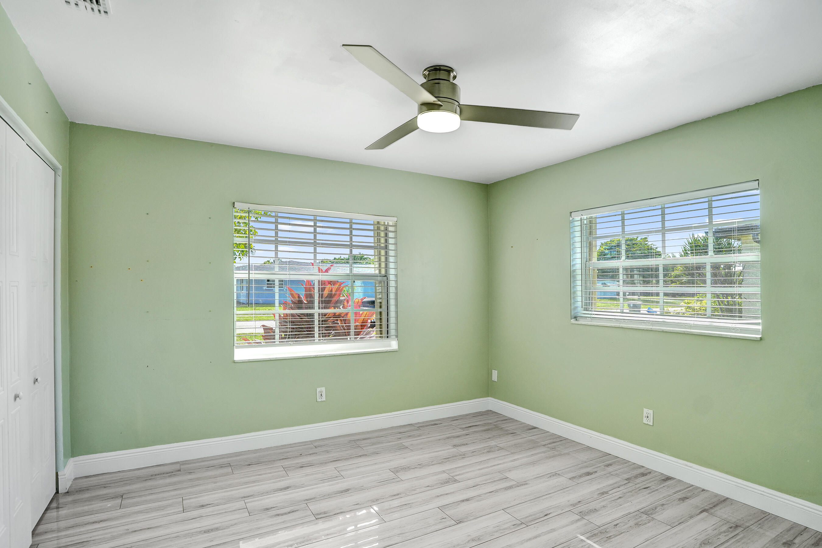 22335 Boulder Street Boca Raton, FL 33428 - Photo 20 of 36 a view of an empty room with wooden floor and a window