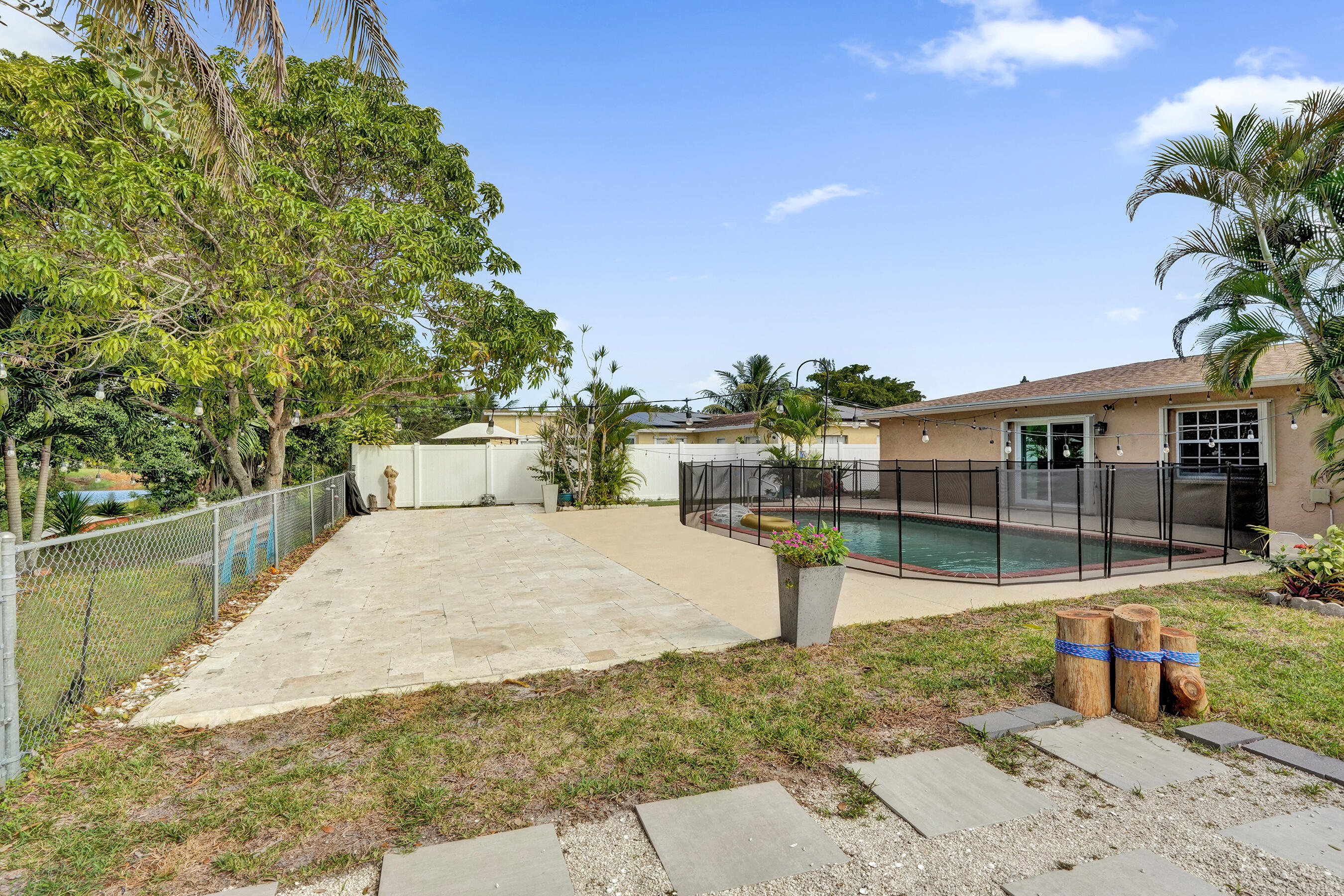 22335 Boulder Street Boca Raton, FL 33428 - Photo 32 of 36 a view of a swimming pool with a patio