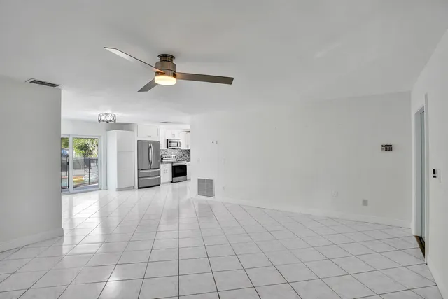 a view of a kitchen with microwave and furniture