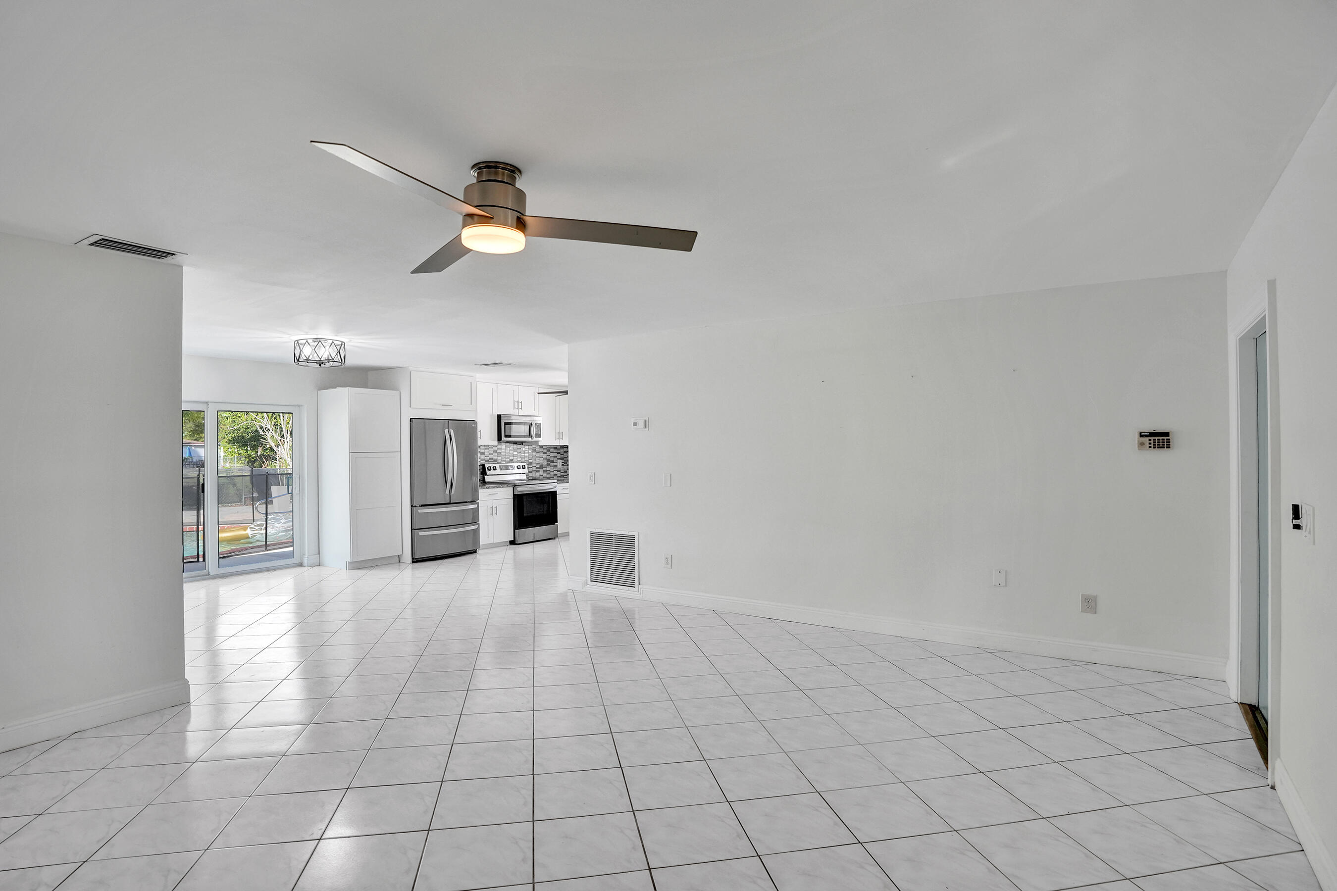 22335 Boulder Street Boca Raton, FL 33428 - Photo 6 of 36 a view of a kitchen with microwave and furniture