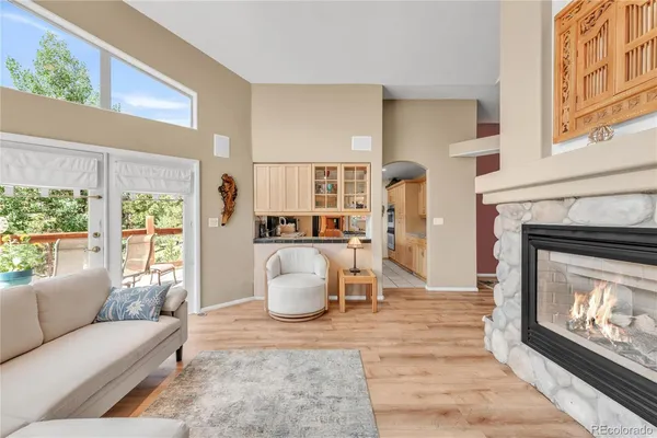 a living room with furniture a window and a fireplace