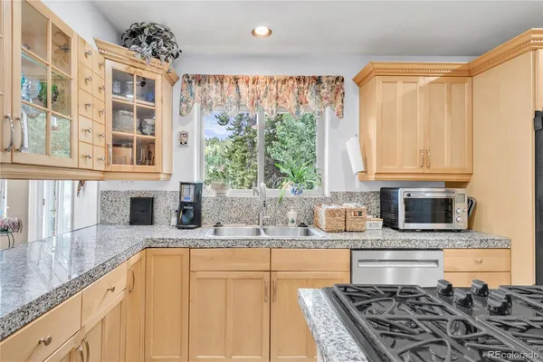 a kitchen with stainless steel appliances granite countertop a stove and a sink