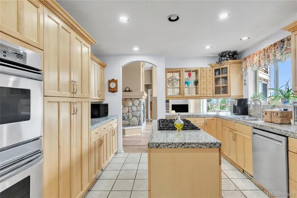 a kitchen with stainless steel appliances granite countertop a stove and a microwave