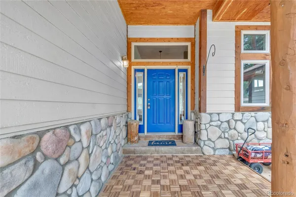 a view of front door of house with stairs