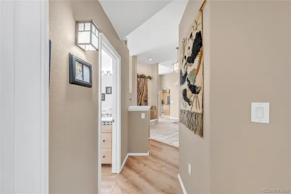 a view of a hallway with wooden floor and entryway
