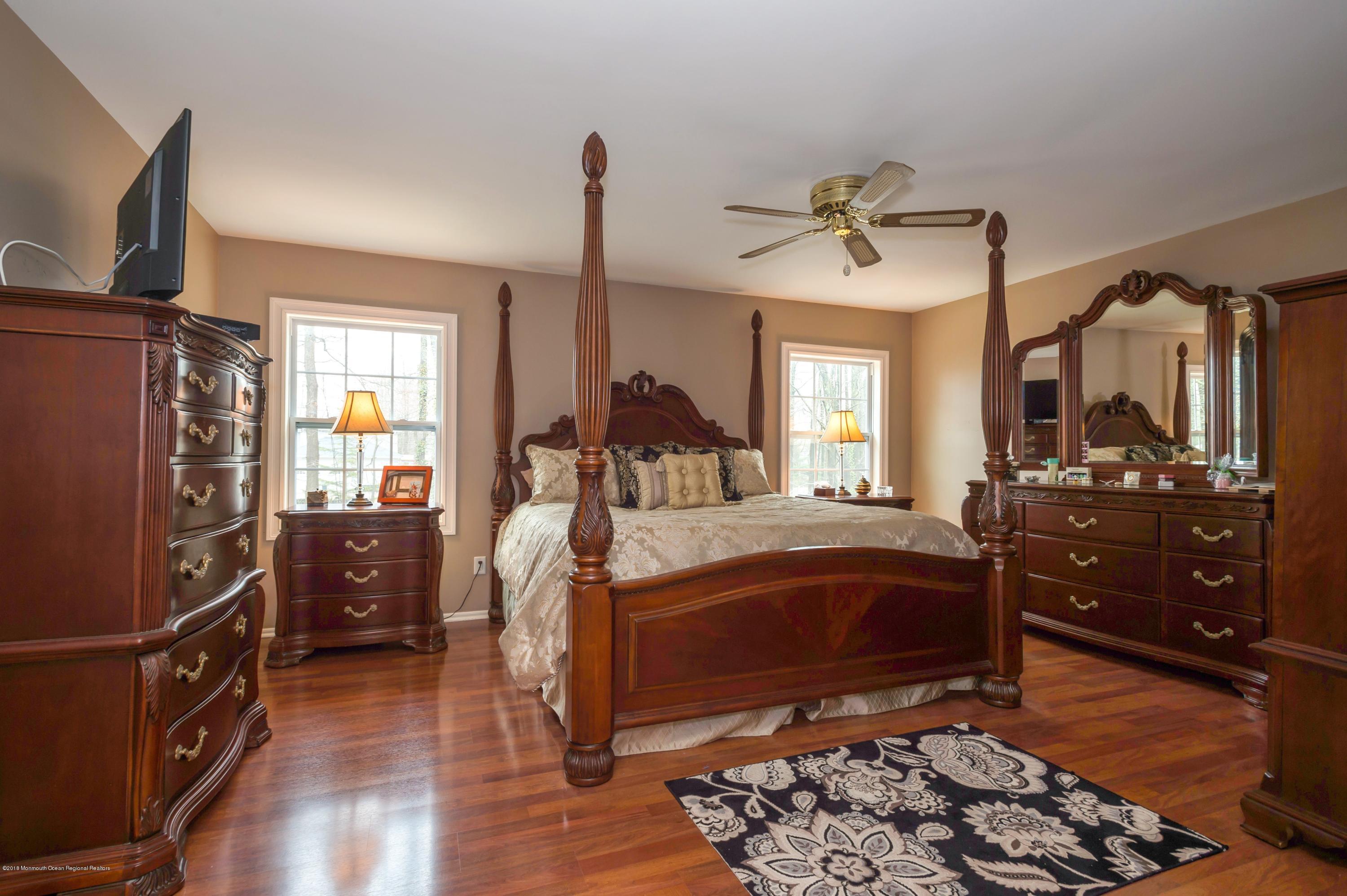 17 Walnut Court Matawan, NJ 07747 - Photo 12 of 17 a bedroom with a bed dresser and a window