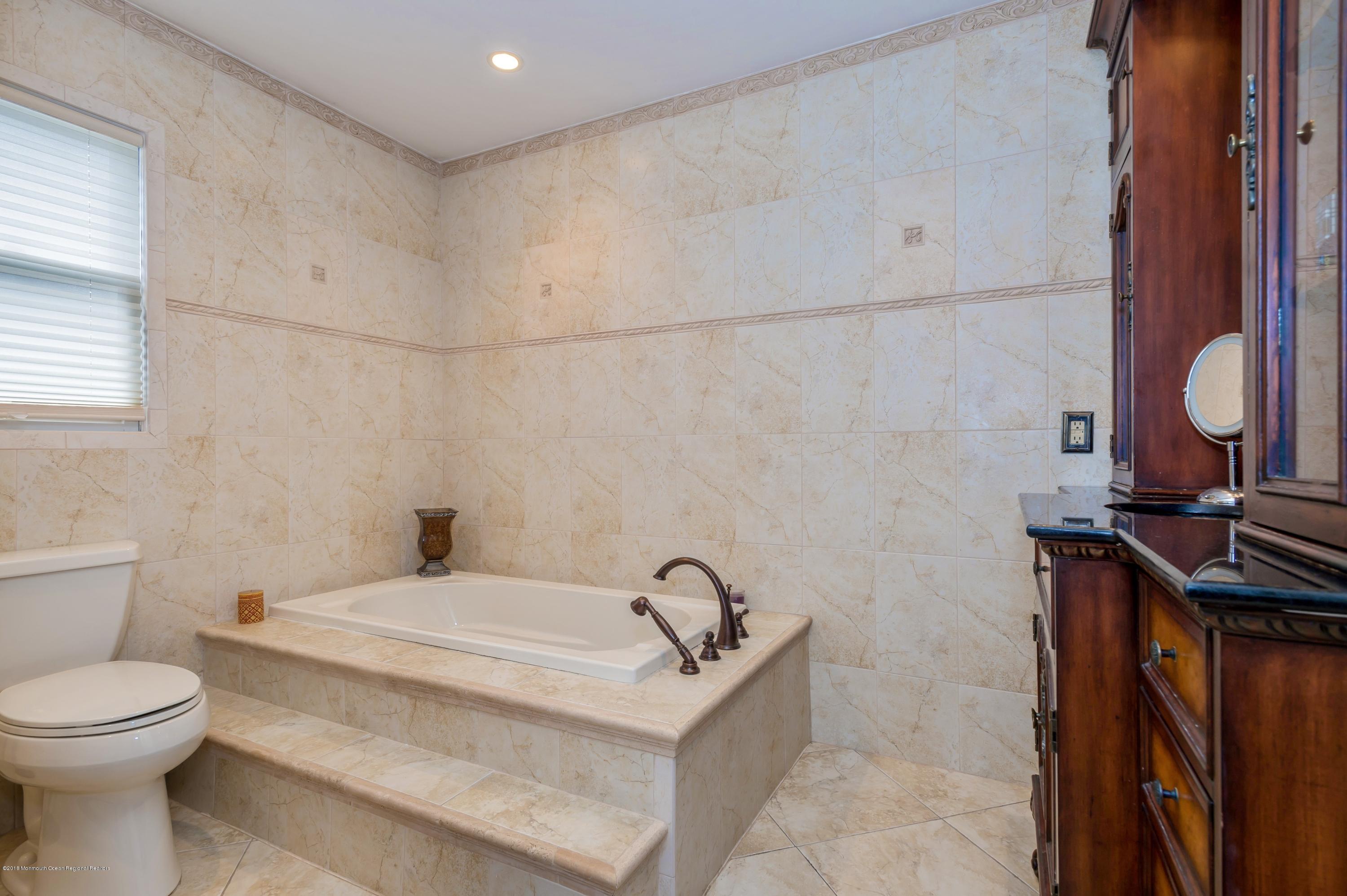 17 Walnut Court Matawan, NJ 07747 - Photo 13 of 17 a bathroom with a sink a toilet and a mirror