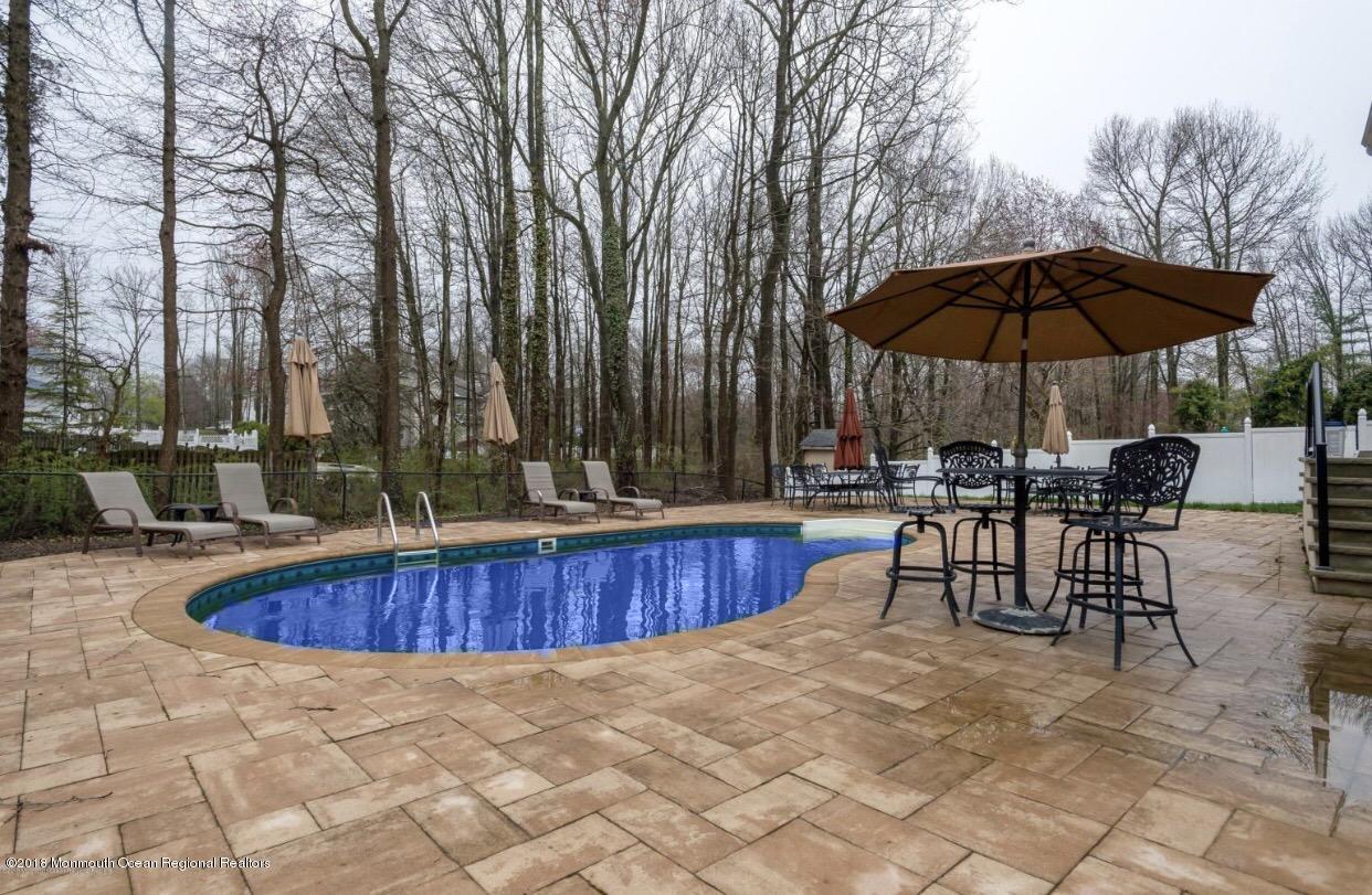 17 Walnut Court Matawan, NJ 07747 - Photo 17 of 17 a view of patio with swimming pool table and chairs