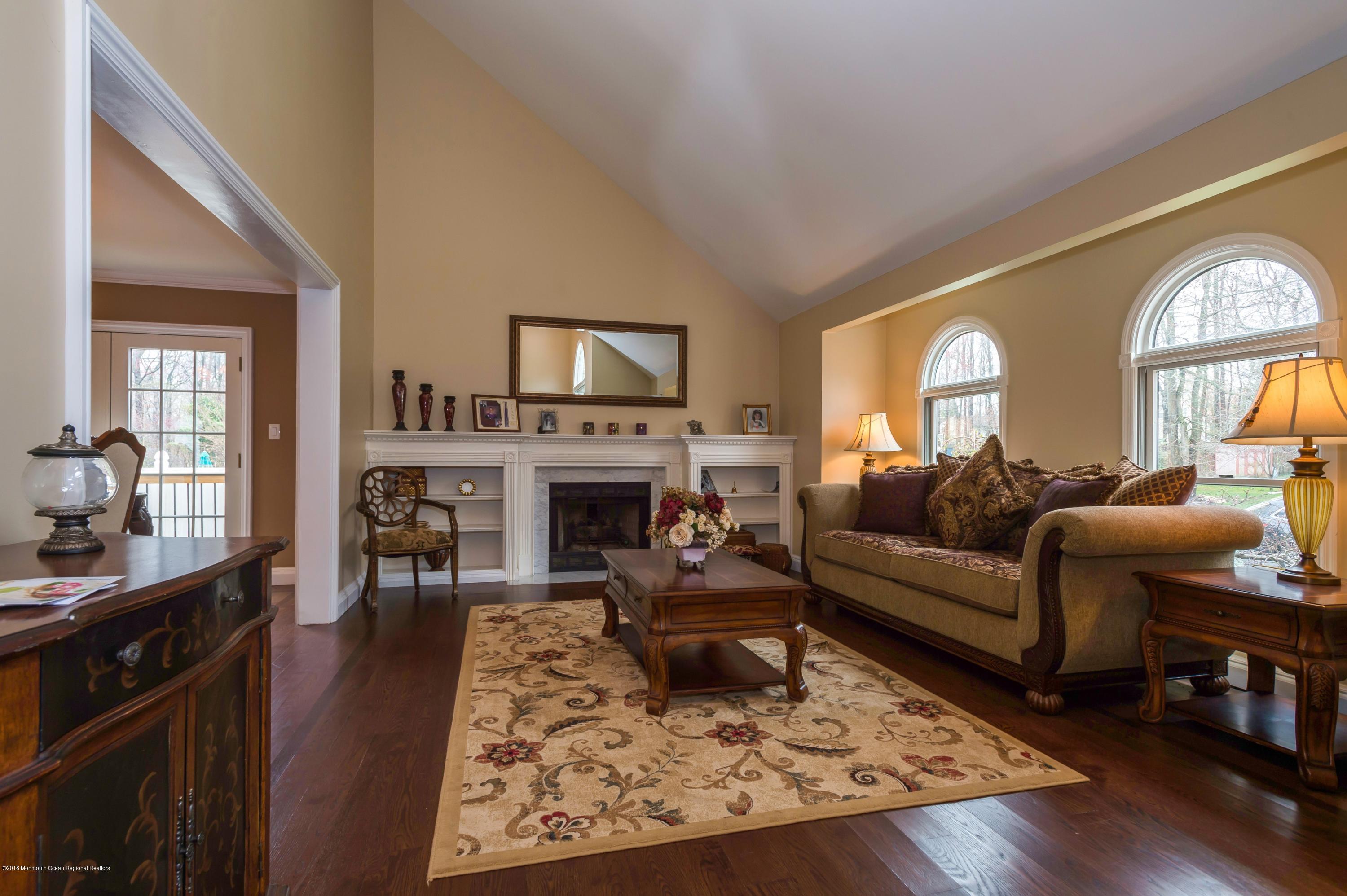17 Walnut Court Matawan, NJ 07747 - Photo 3 of 17 a living room with furniture hard wood floor and a fireplace