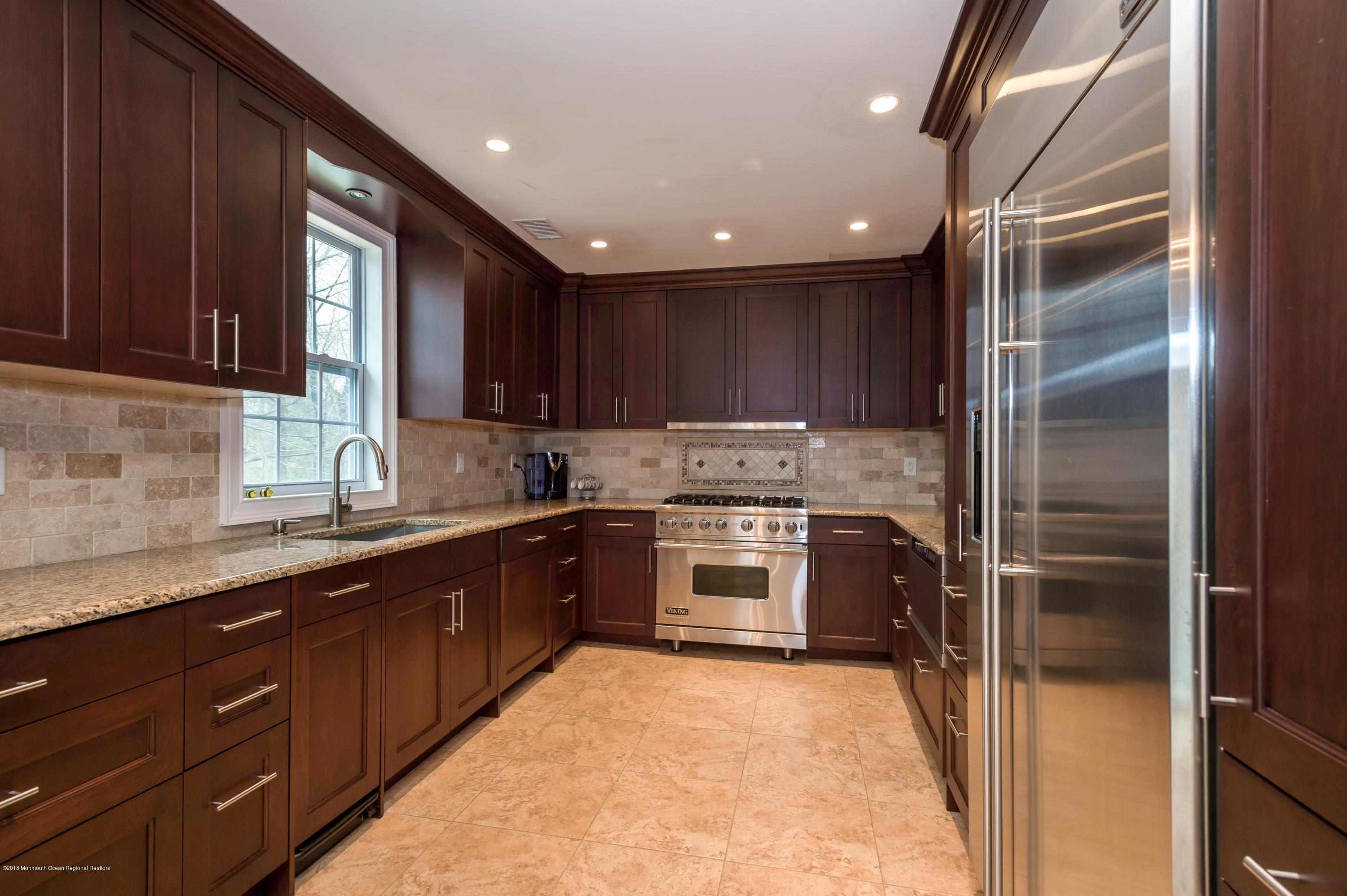 17 Walnut Court Matawan, NJ 07747 - Photo 4 of 17 a large kitchen with granite countertop a refrigerator and a sink