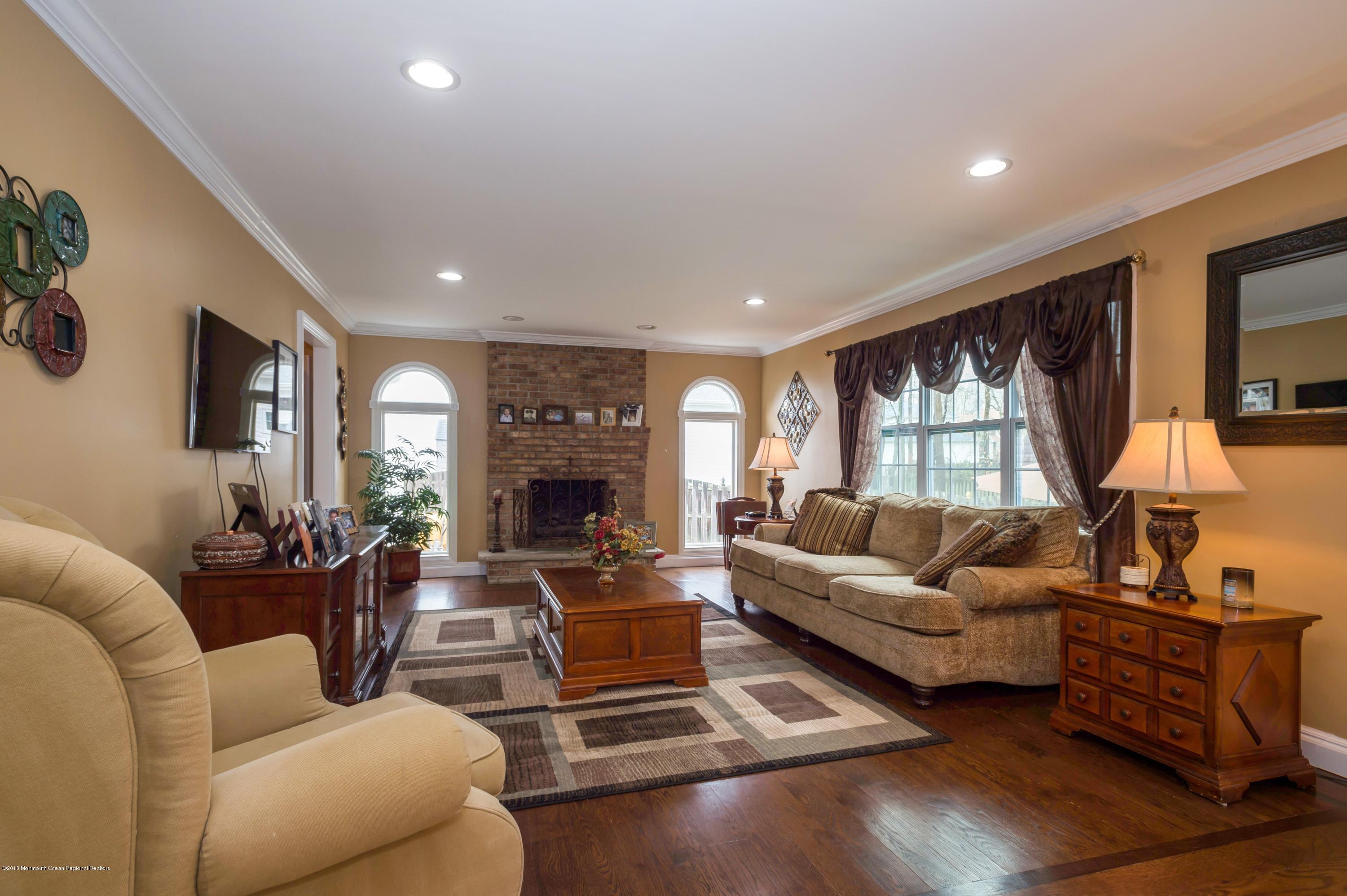 17 Walnut Court Matawan, NJ 07747 - Photo 6 of 17 a living room with furniture fireplace and a flat screen tv