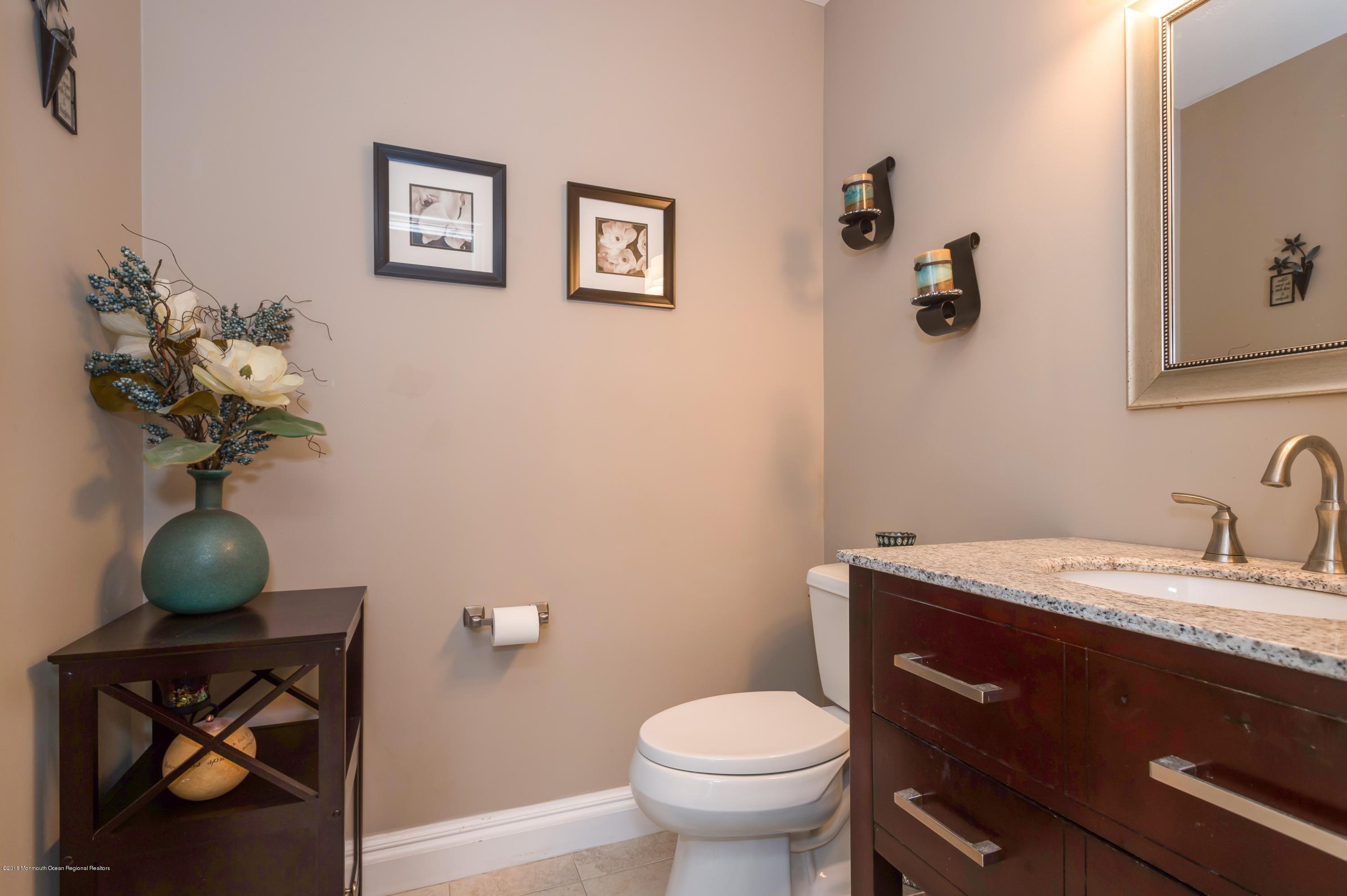 17 Walnut Court Matawan, NJ 07747 - Photo 10 of 17 a bathroom with a toilet sink and mirror