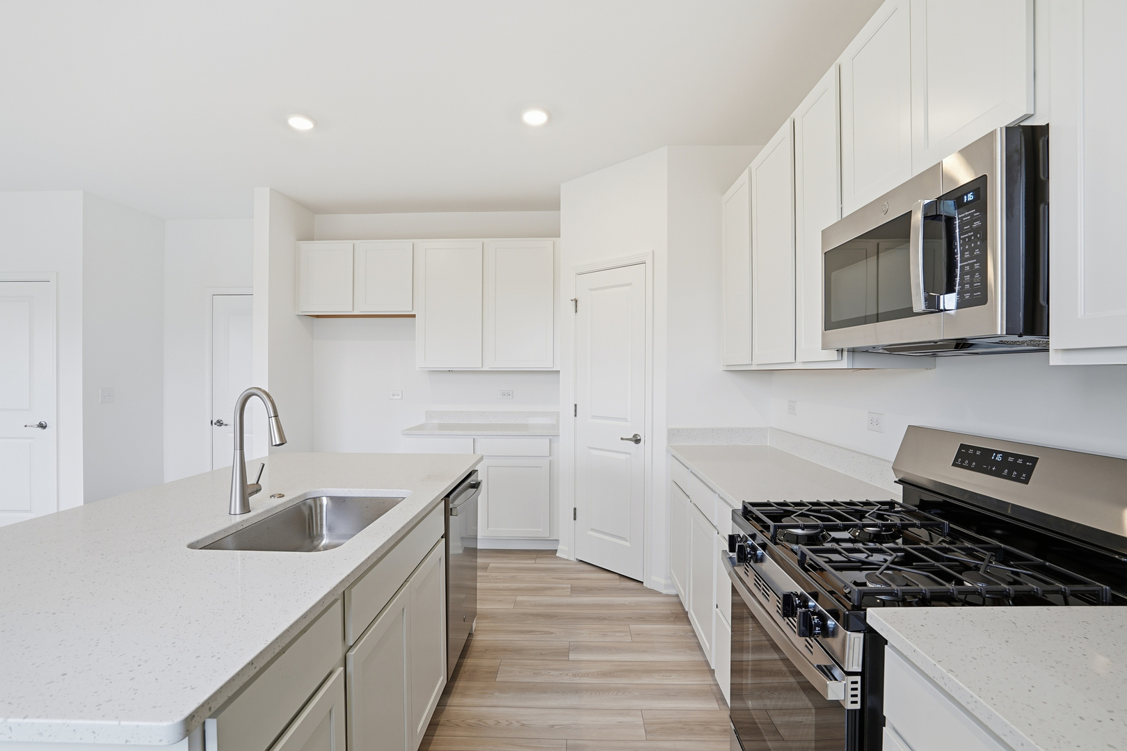 342 Danforth Drive Oswego, IL 60543 - Photo 9 of 21 a kitchen with stainless steel appliances granite countertop a sink stove and cabinets