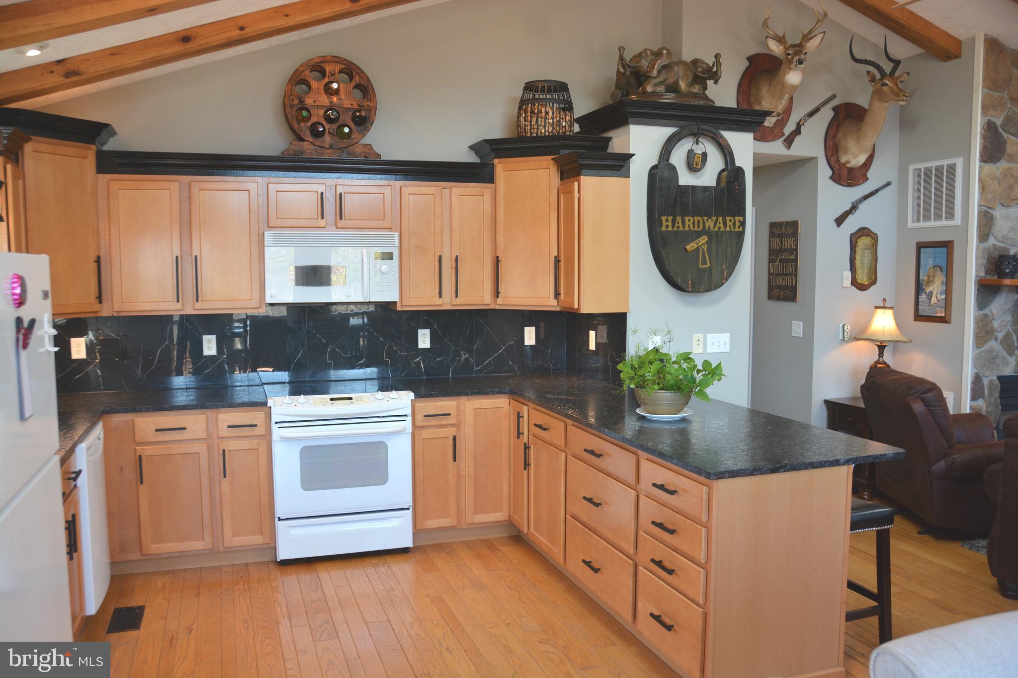 400 Locust Ridge Moorefield, WV 26836 - Photo 18 of 87 a kitchen with stainless steel appliances white cabinets a stove a sink and a window
