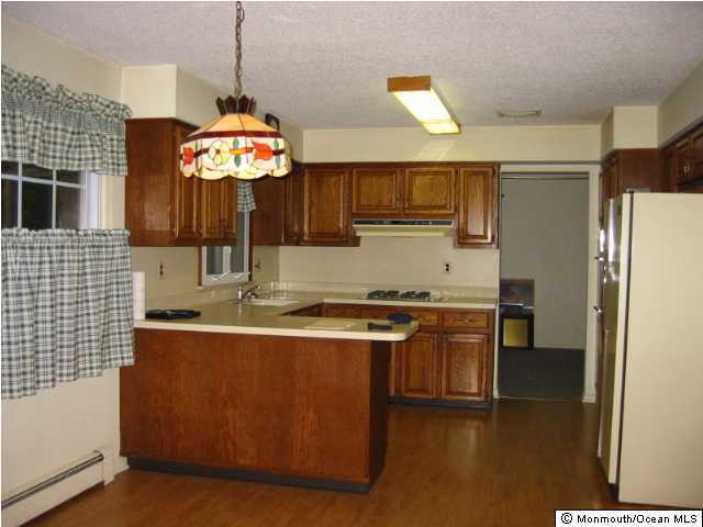 569 Harbor Road Brick, NJ 08724 - Photo 2 of 3 a kitchen with stainless steel appliances granite countertop a sink a stove and a refrigerator