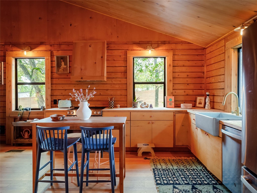 127 Marina Road Smithville, TX 78957 - Photo 11 of 40 a kitchen with stainless steel appliances granite countertop a stove a sink and a refrigerator