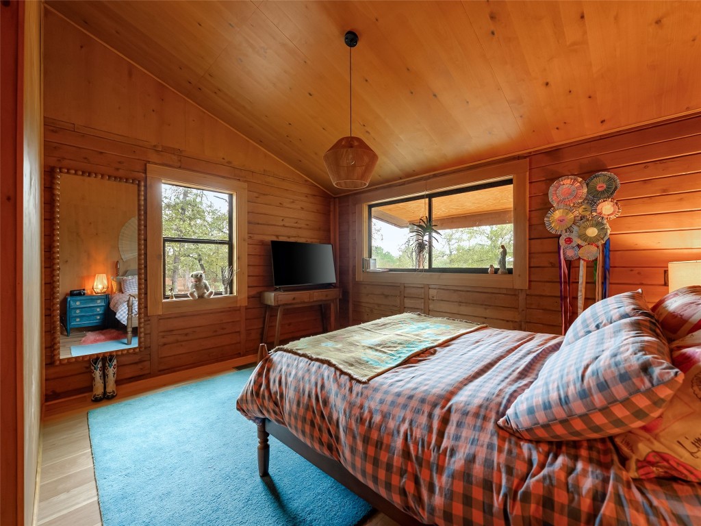 127 Marina Road Smithville, TX 78957 - Photo 17 of 40 a bedroom with a bed and a flat tv screen