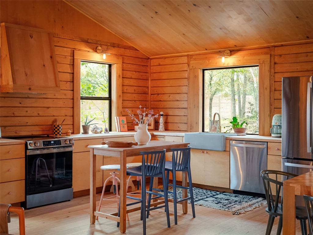 127 Marina Road Smithville, TX 78957 - Photo 10 of 40 a kitchen with a stove a sink and a refrigerator