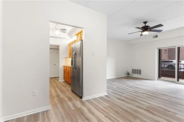 a kitchen with stainless steel appliances granite countertop a sink refrigerator and cabinets