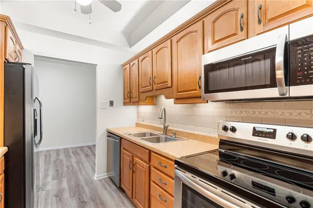 a kitchen with stainless steel appliances a refrigerator and a sink