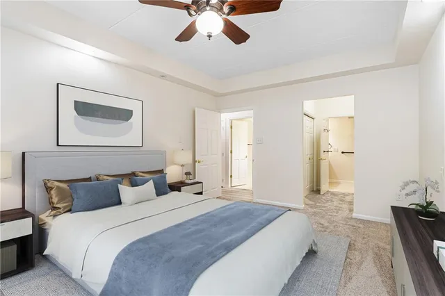 an empty room with a window and a ceiling fan