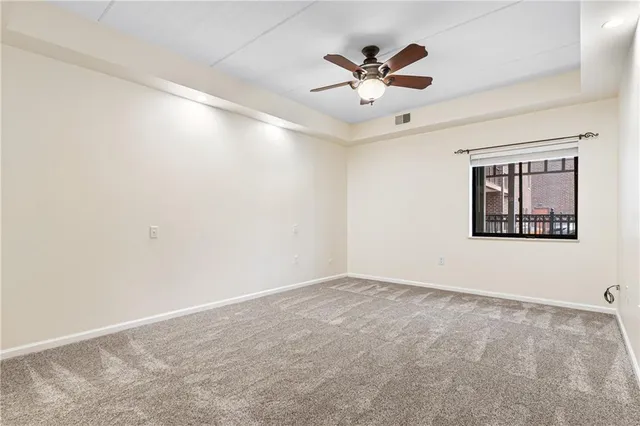 a view of a hallway with wooden floor and closet