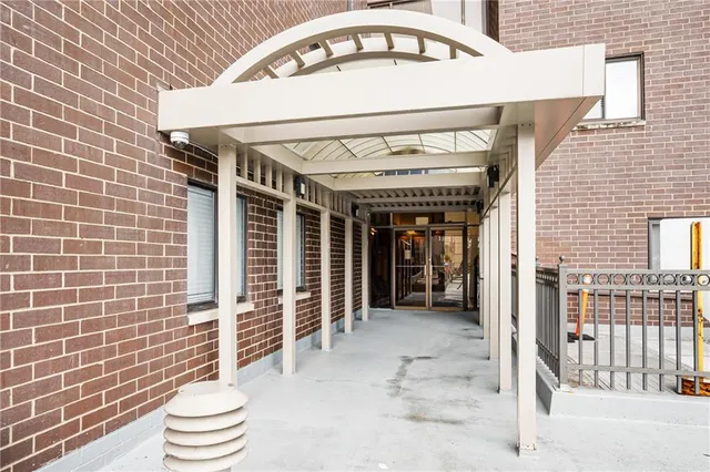 a view of a hallway with wooden floor and entryway