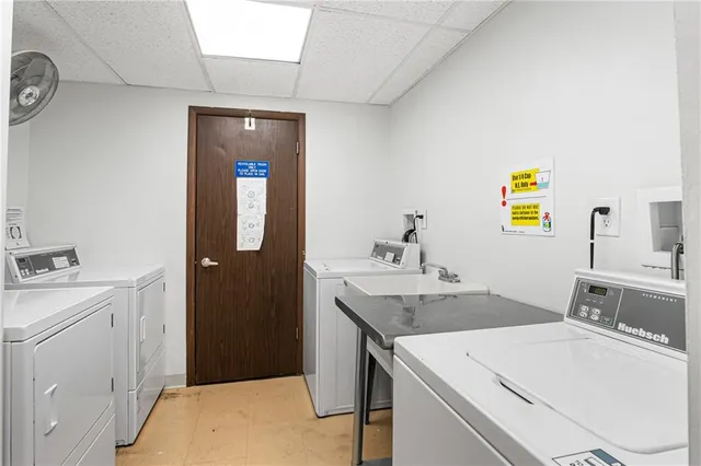 a view of a dining room with furniture a potted plant and wooden floor